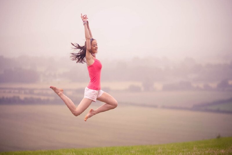 Woman Jumping in Field — Pink