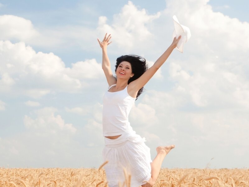Woman Jumping in Field — White