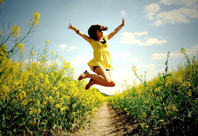Woman Jumping in Field — Yellow