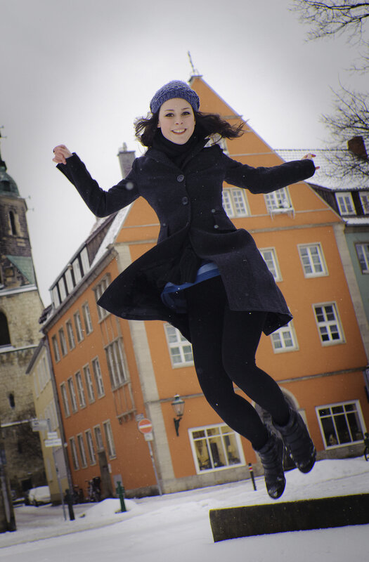 Woman jumping in snow