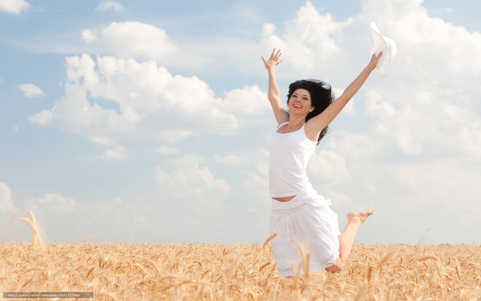 Woman jumping in wheat field