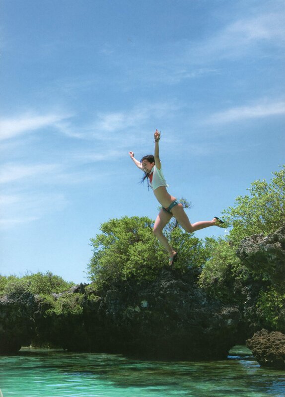 woman jumping into ocean