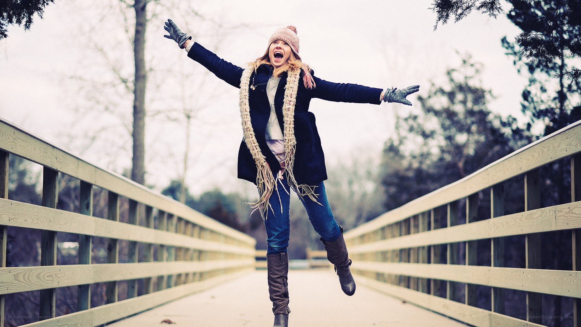 Woman jumping on a bridge