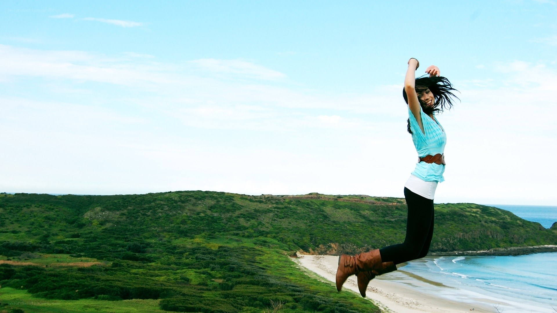 Woman jumping on a cliff