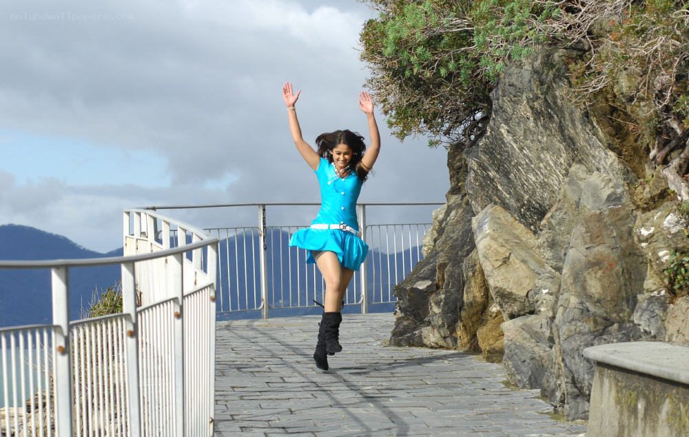 Woman jumping on a coastal path