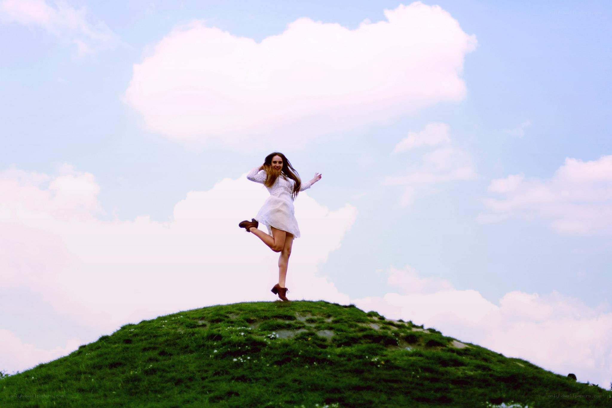 Woman jumping on a hill