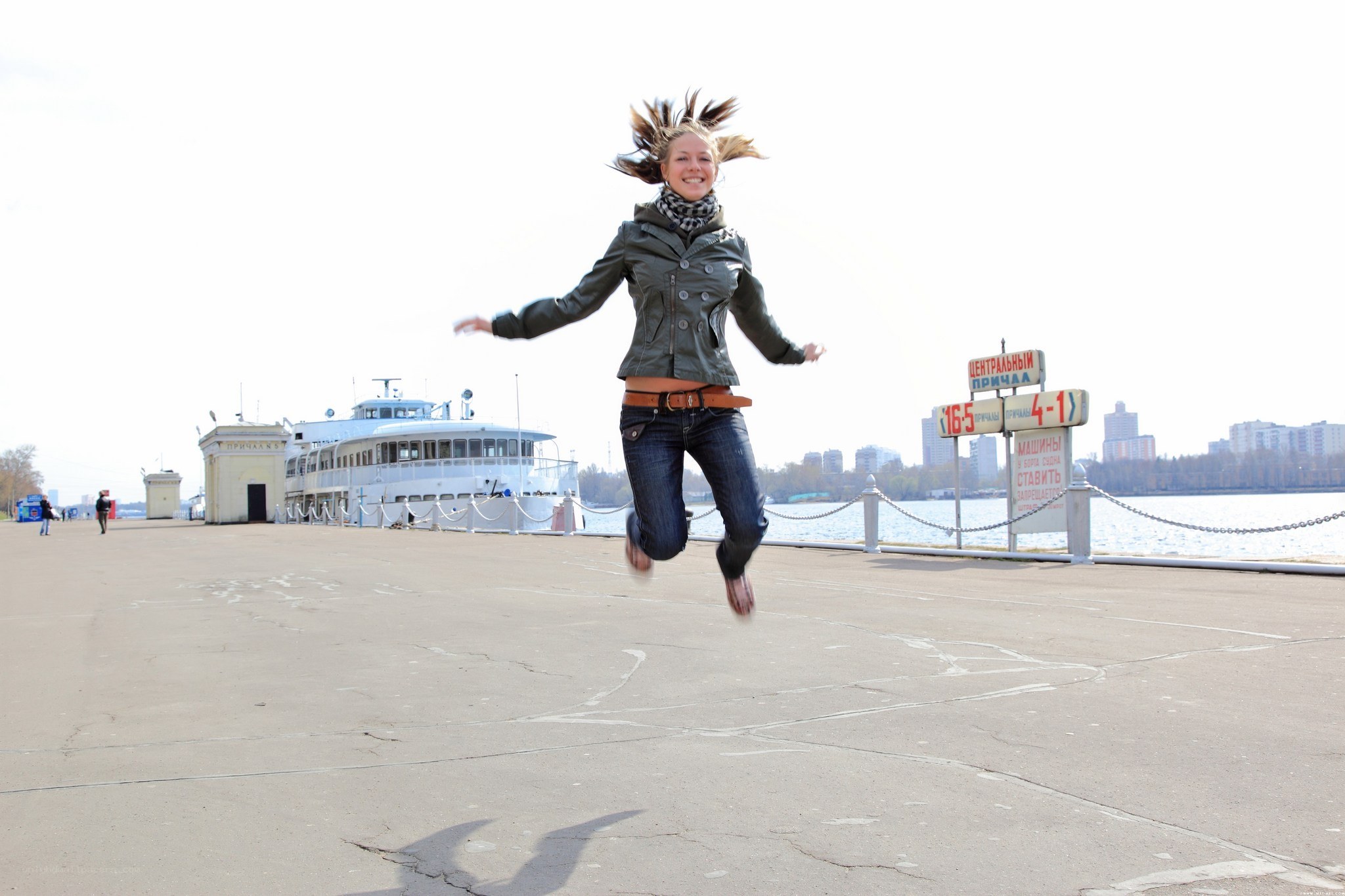 Woman jumping on a pier