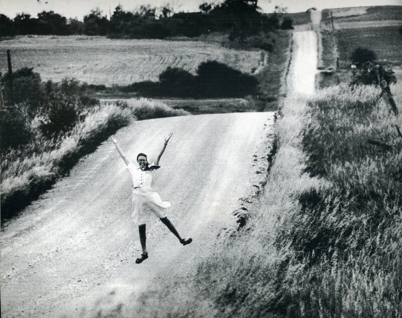 Woman jumping on a rural road