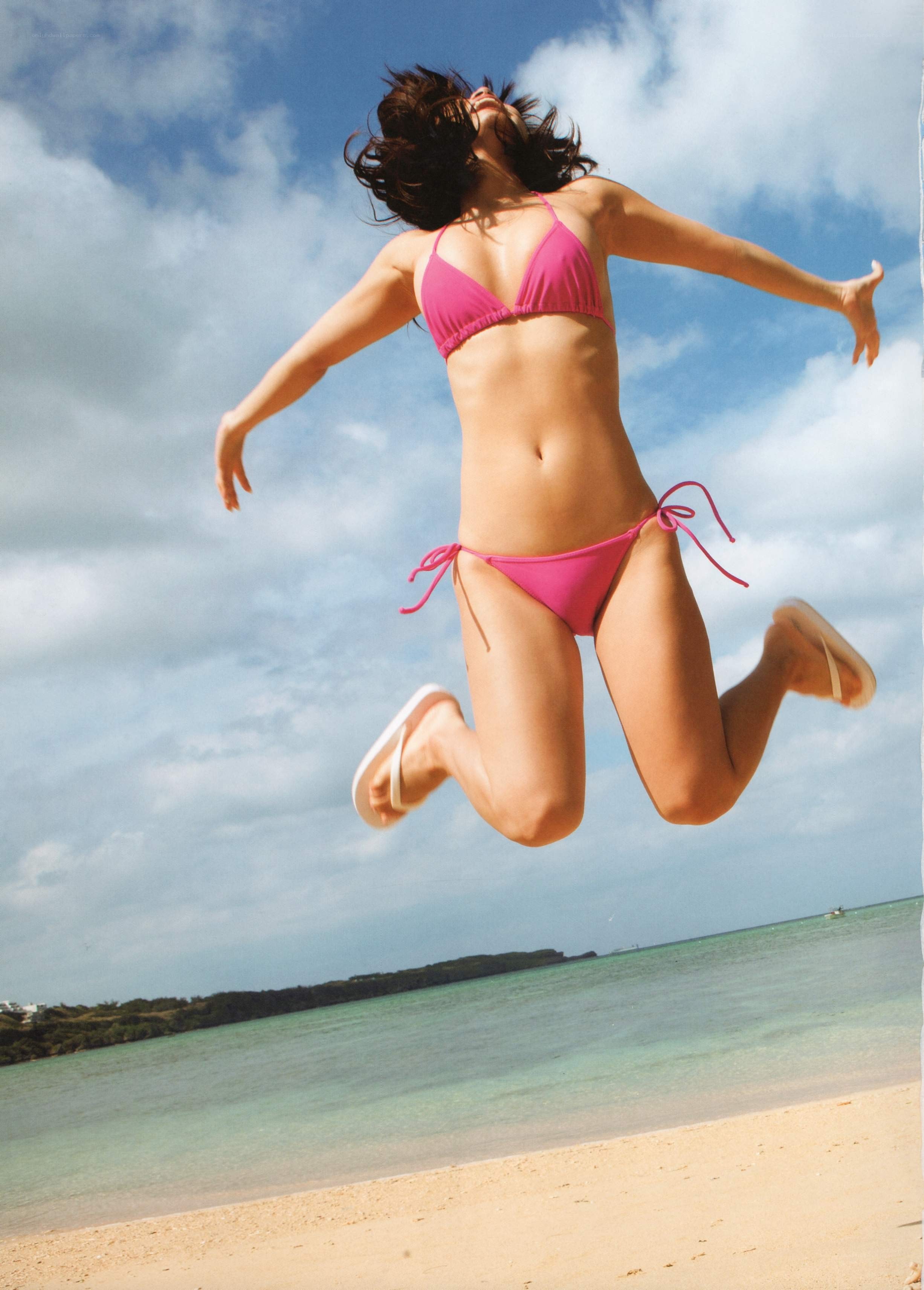 Woman jumping on beach