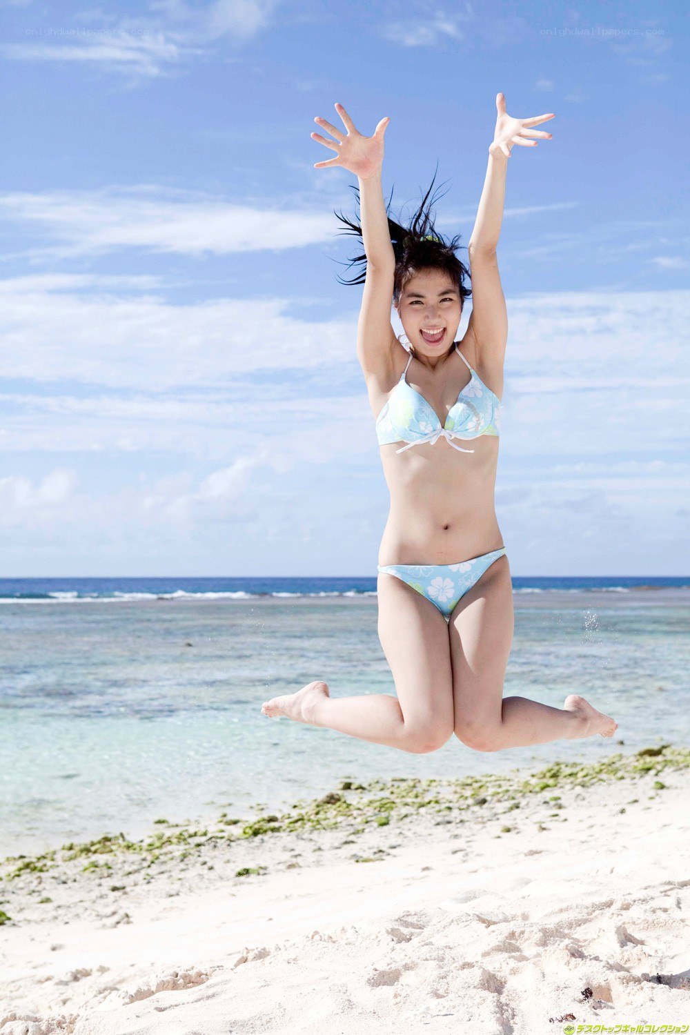 Woman jumping on beach