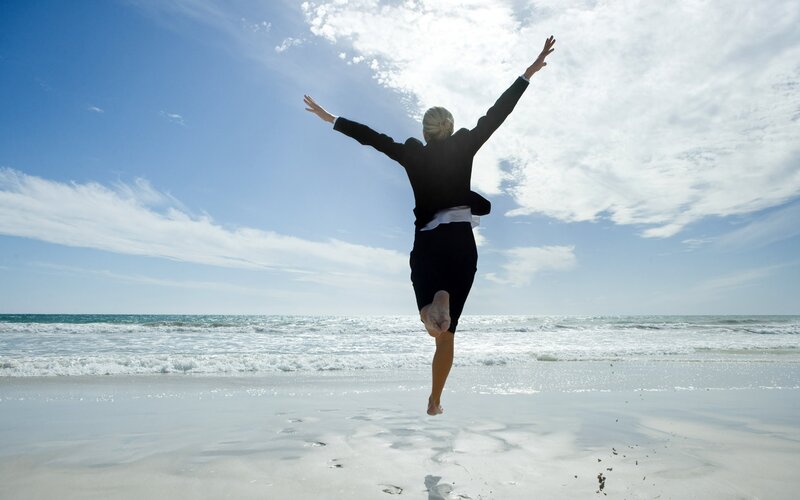 woman jumping on beach
