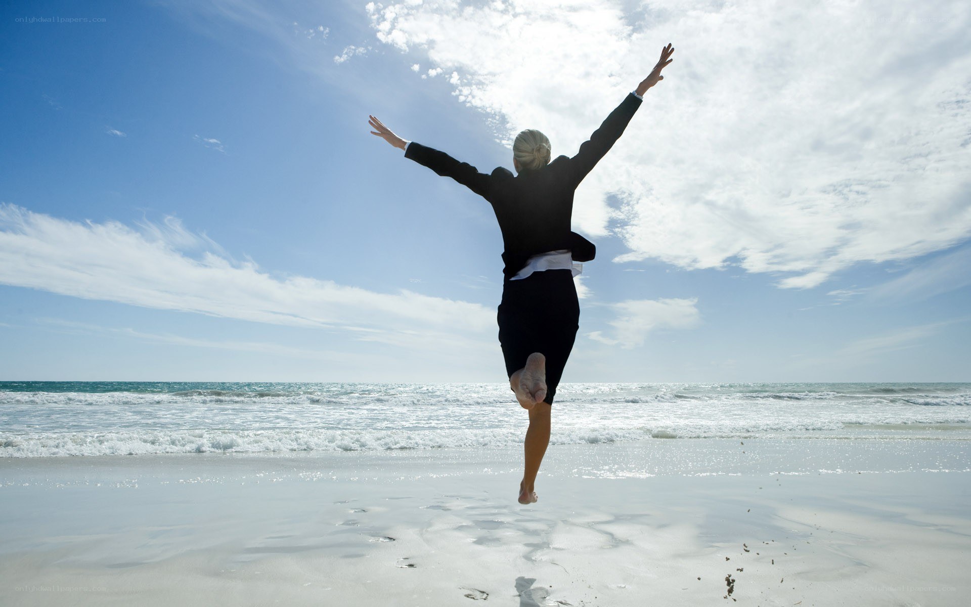 woman jumping on beach