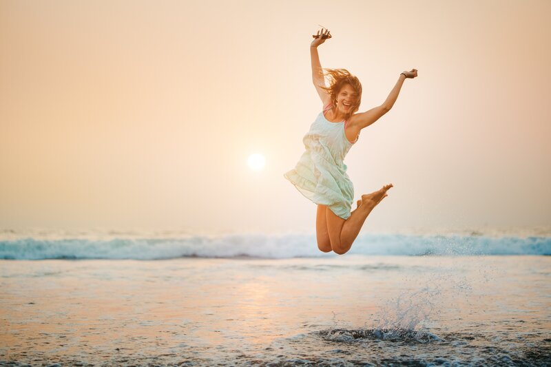 Woman Jumping on Beach — Orange, Joyful