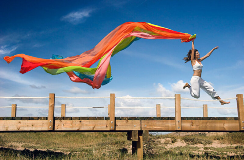 Woman Jumping on Bridge