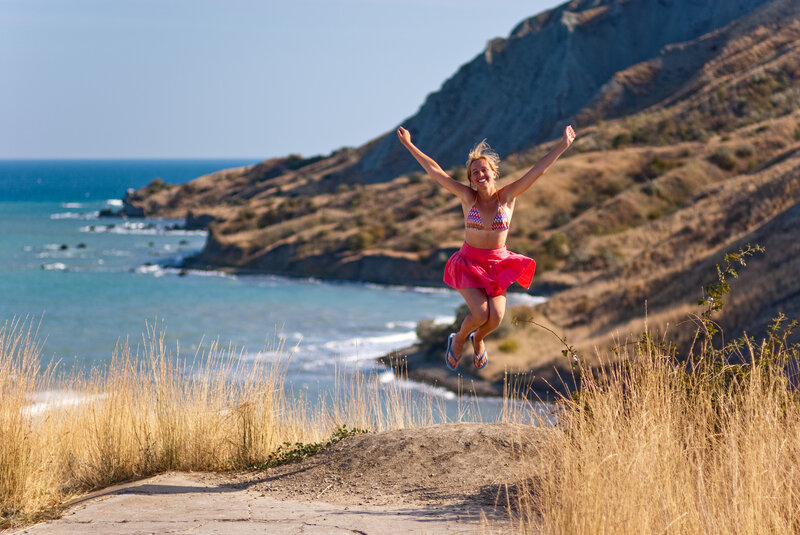 Woman Jumping on Cliff — Blue