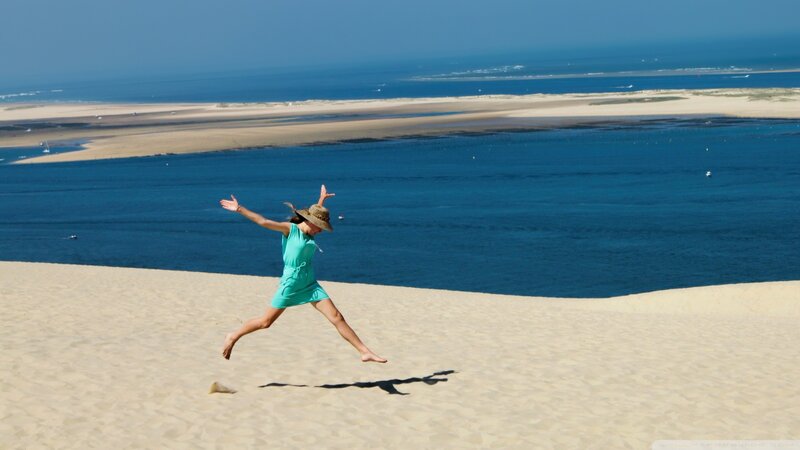 Woman Jumping on Dune