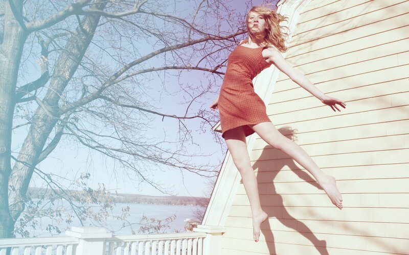 Woman jumping on porch