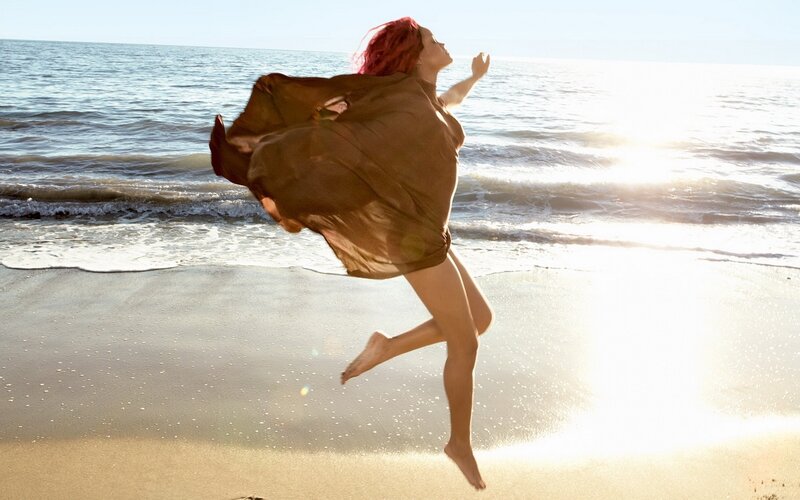 Woman jumping on the beach