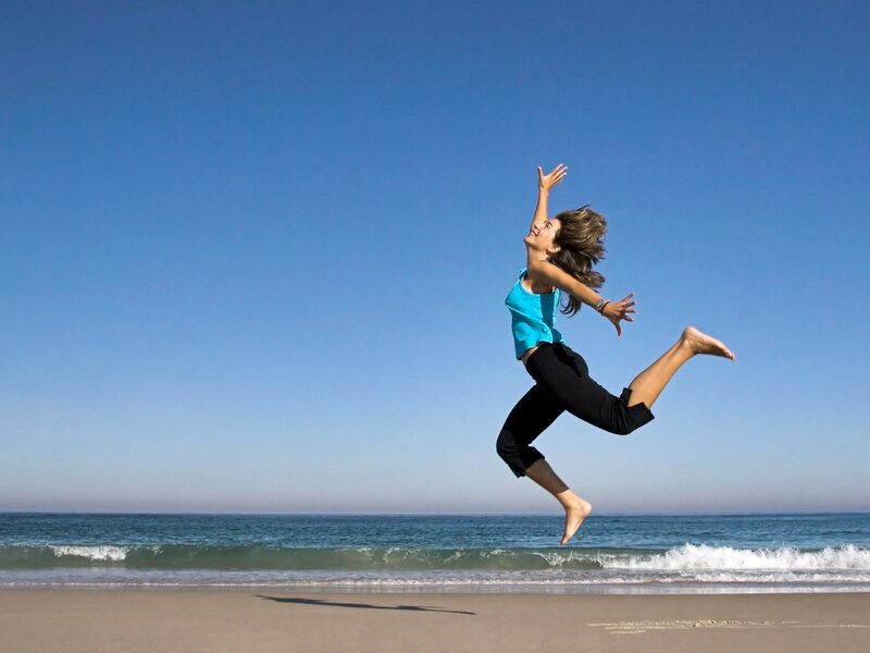 Woman jumping on the beach