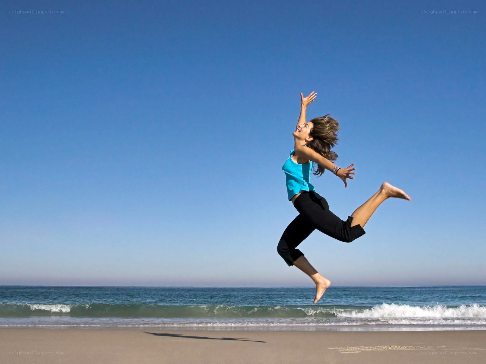 Woman jumping on the beach