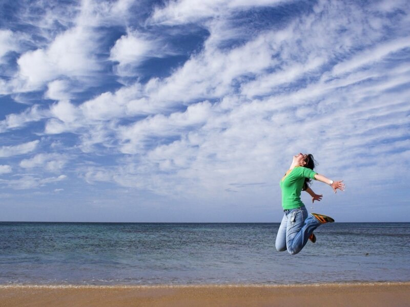 Woman jumping on the beach