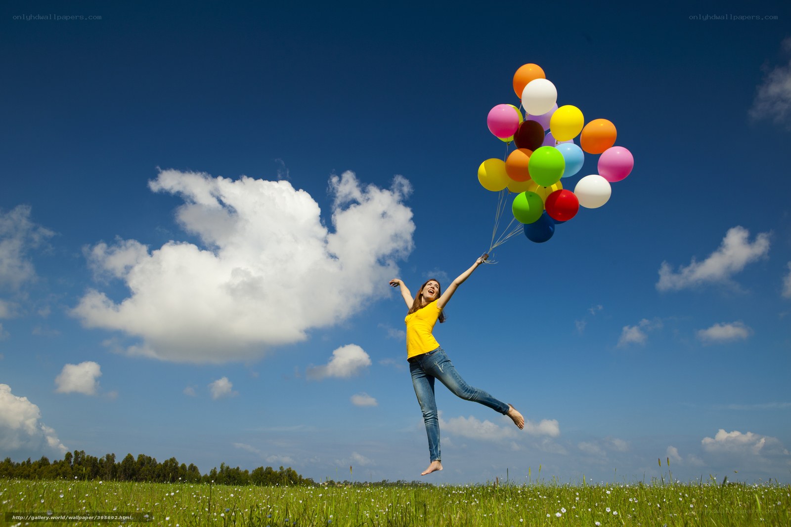 Woman jumping with balloons