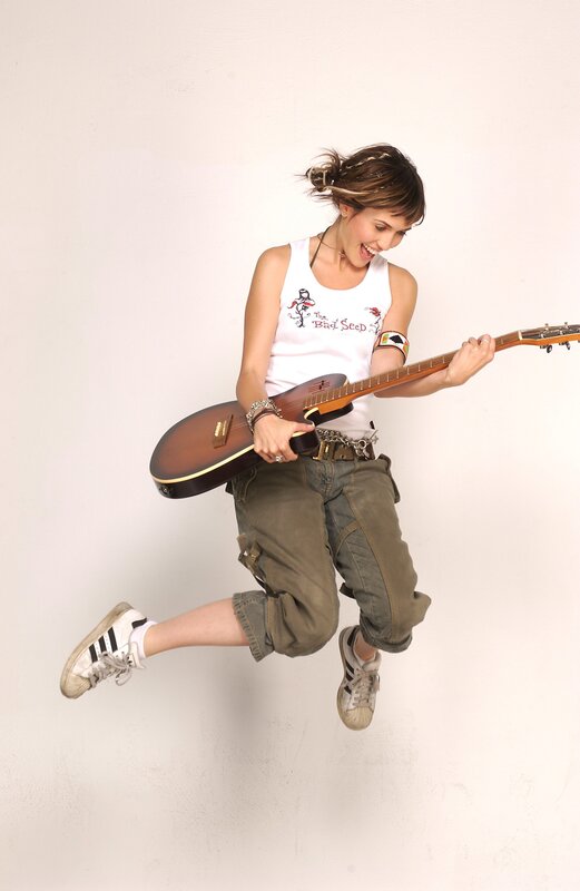 woman jumping with guitar