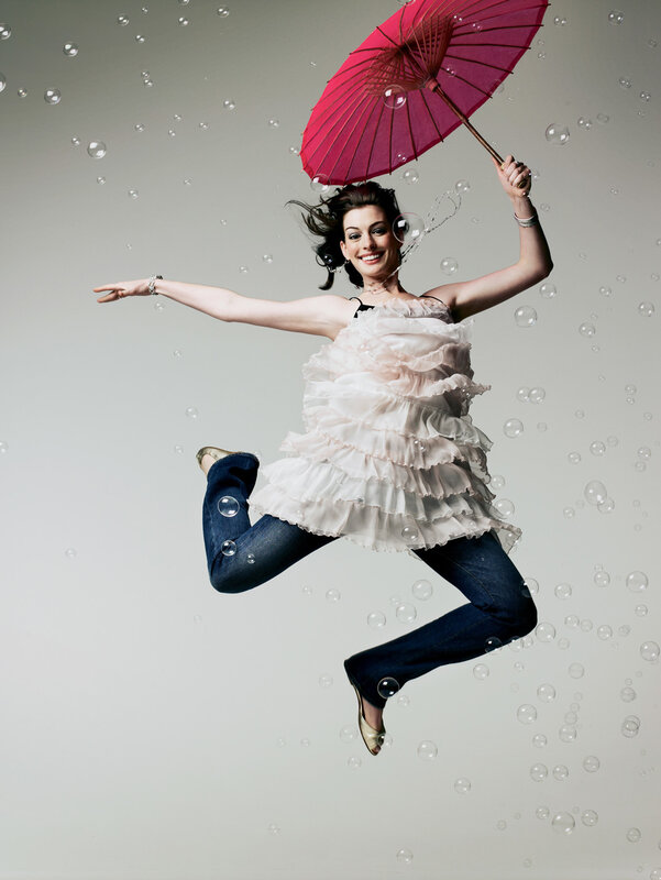 woman jumping with pink umbrella