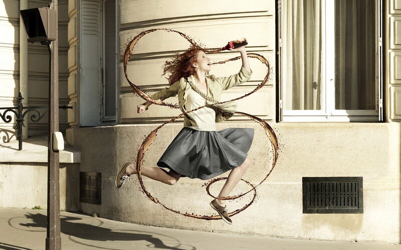 Woman jumping with soda splash