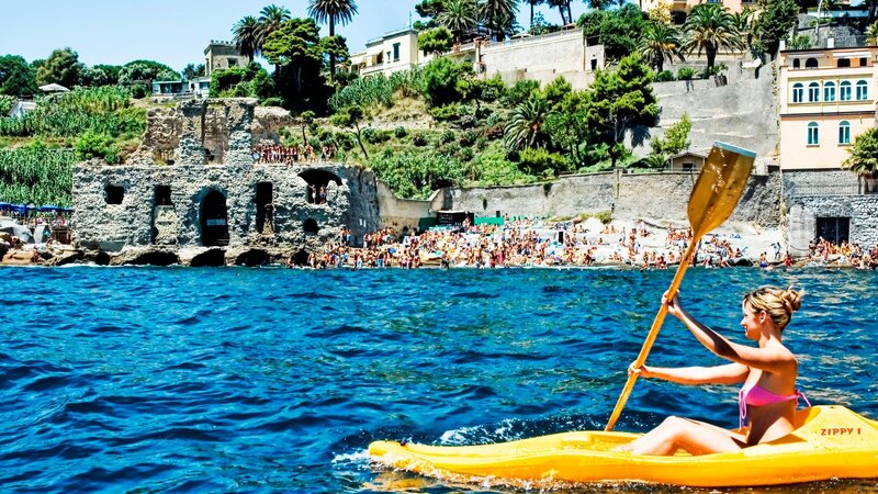 Woman kayaking near beach