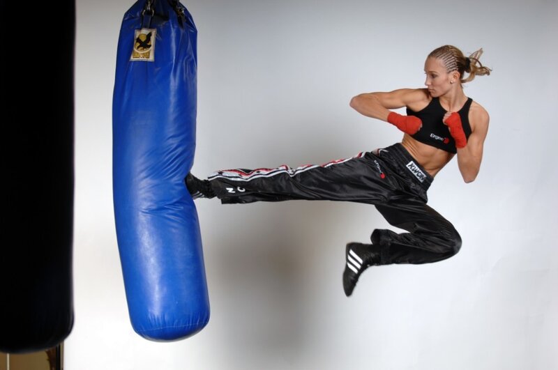 Woman Kicking Punching Bag — Blue