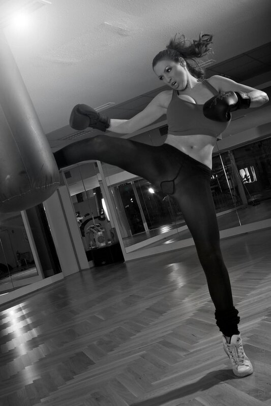 woman kicking punching bag