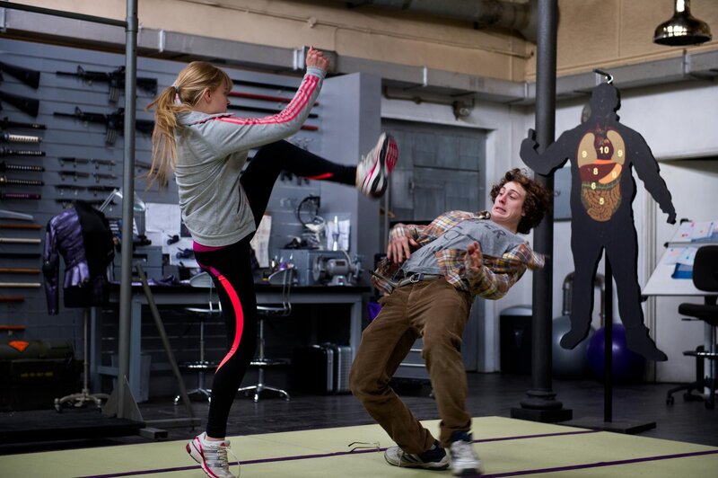 Woman kicks man in training room