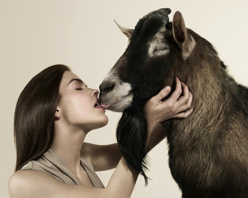 woman kissing a goat