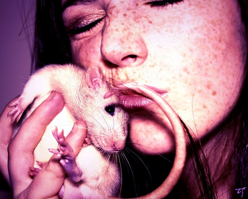 woman kissing a rat