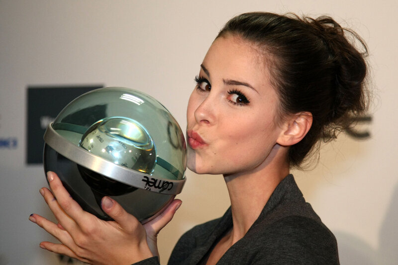 woman kissing a trophy