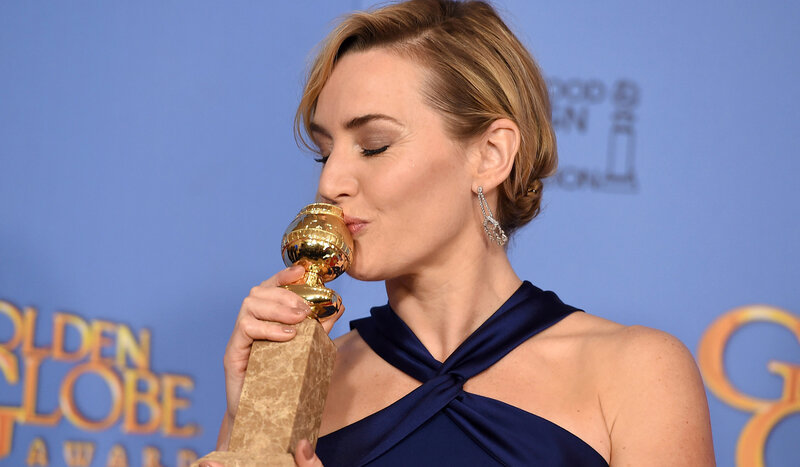 woman kissing golden globe