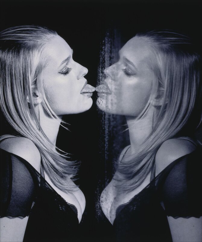 woman kissing her reflection