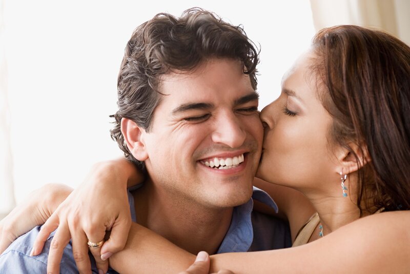 woman kissing man on cheek