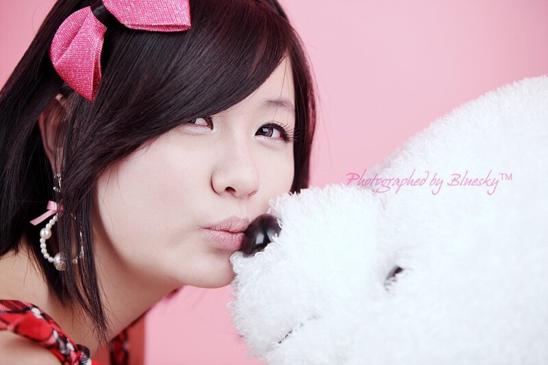woman kissing teddy bear