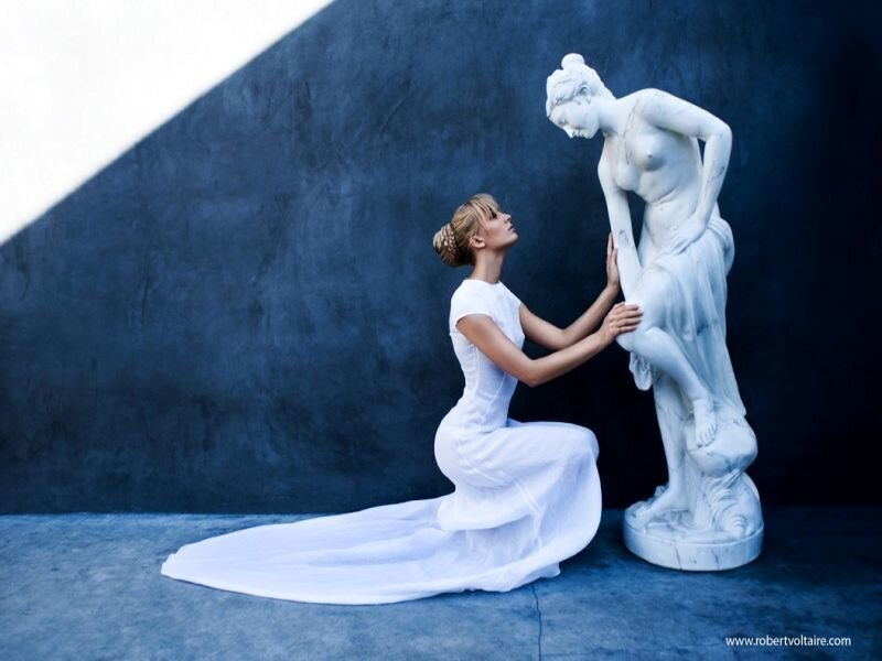 Woman Kneeling Beside Statue
