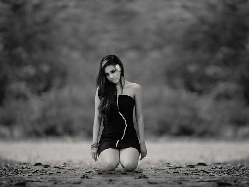 woman kneeling in black dress