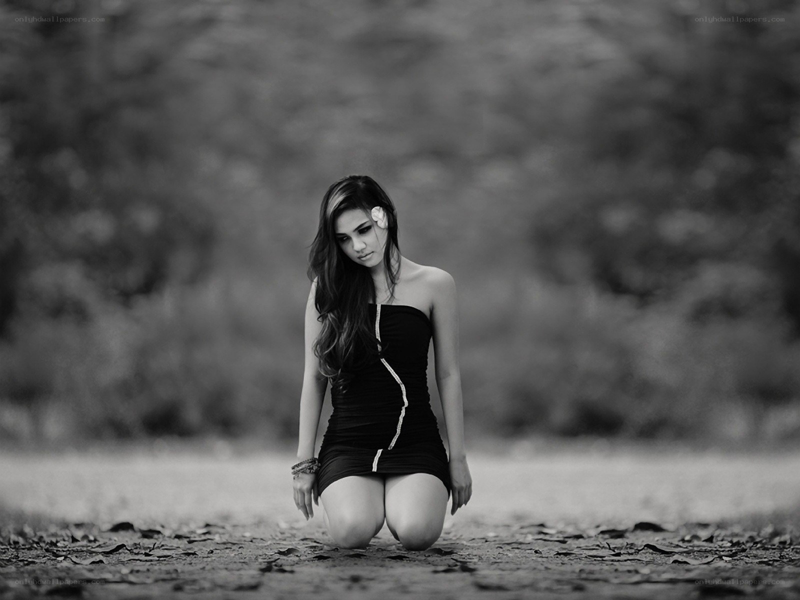 woman kneeling in black dress