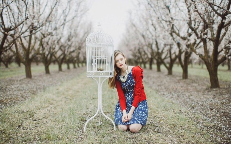 Woman Kneeling in Orchard
