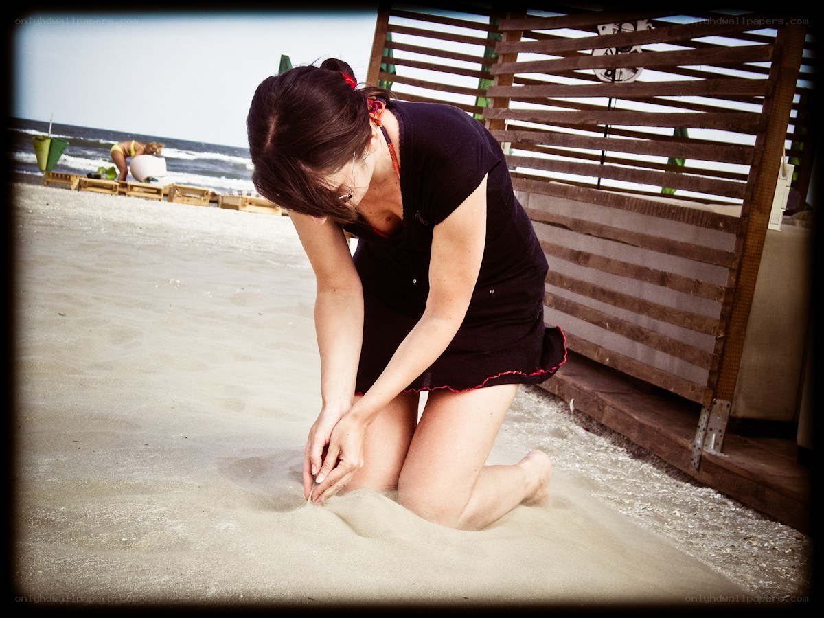 Woman kneeling on beach