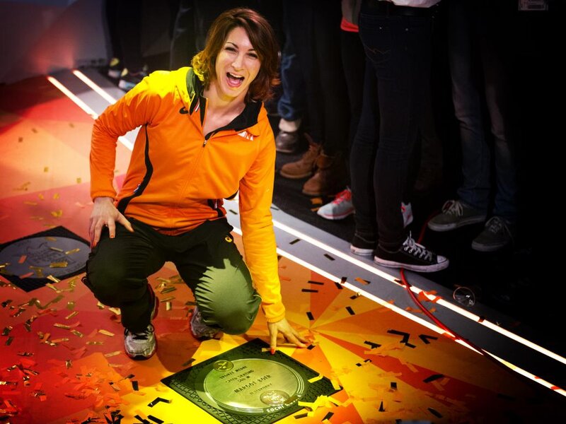 Woman Kneeling on Stage — Orange