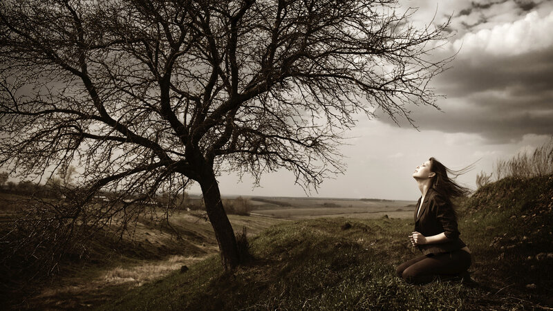 Woman Kneeling under Tree