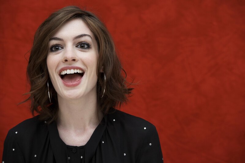 woman laughing against red background