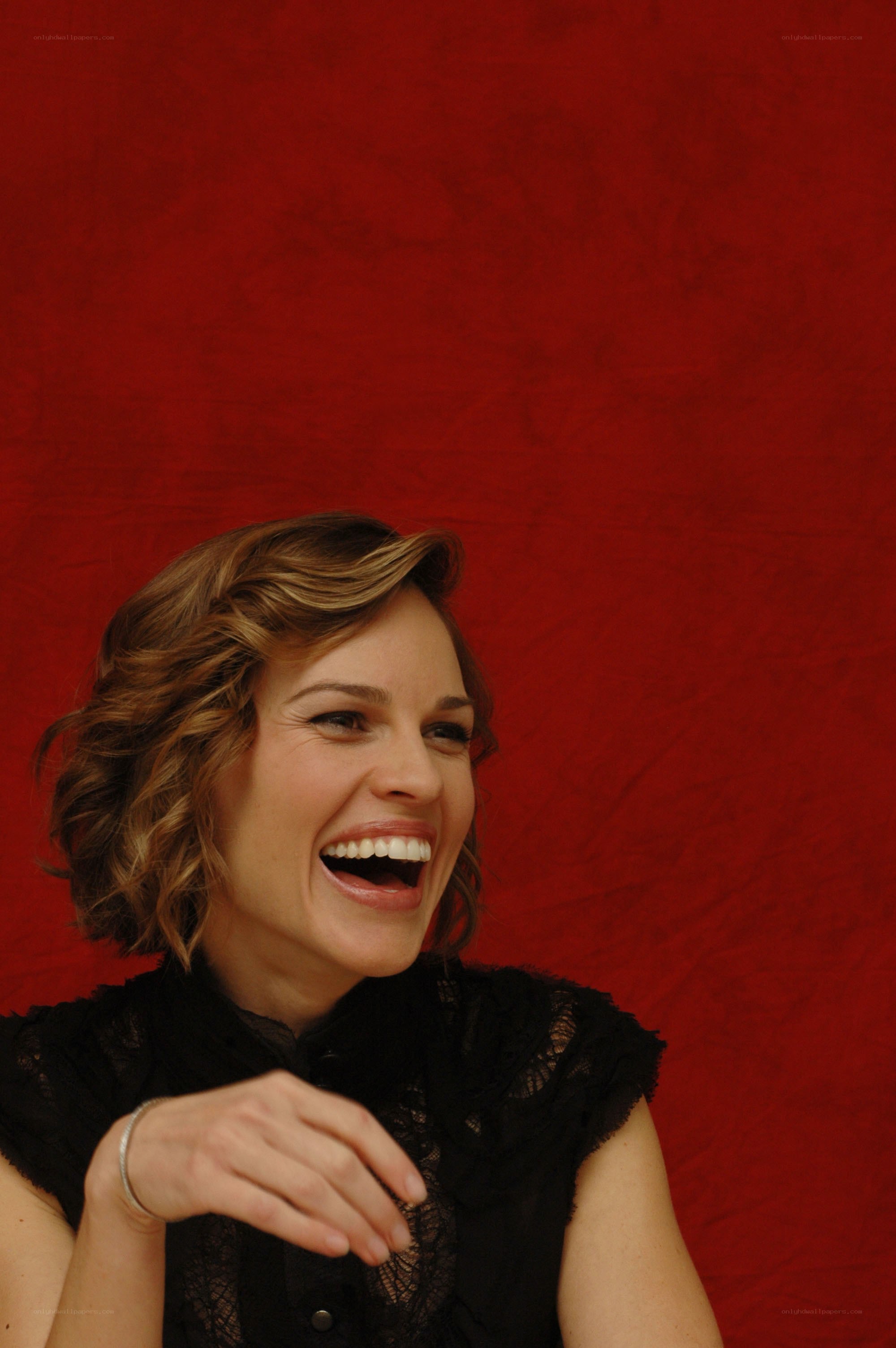 woman laughing against red background
