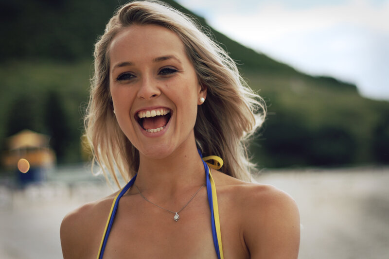 woman laughing at beach